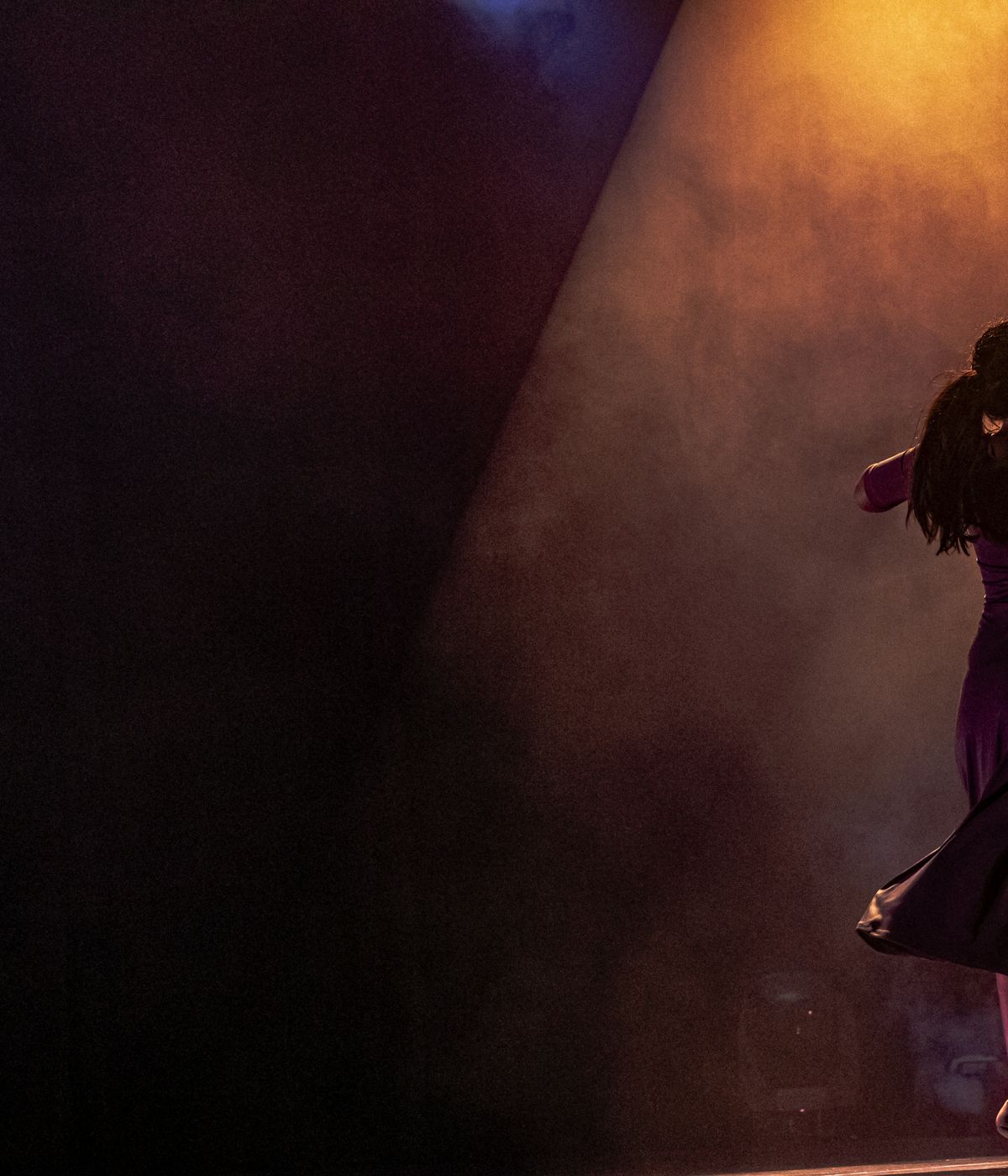 Performer under warm amber stage light